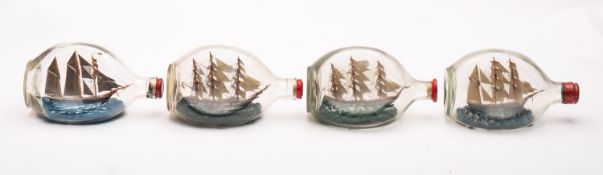 Four various model ships in Dimple Haig bottles, all 20cm long.