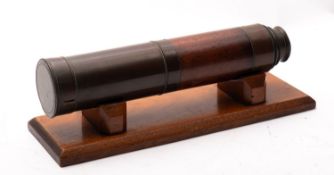 A 19th century mahogany three draw telescope, maker Braham , Bristol, on a later wooden plinth.
