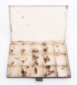An early 20th century lacquer fly tin, together with a small collection of steel eye flies.