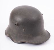 A WWI German steel helmet with Bavarian shield flash to left hand side and remains of original