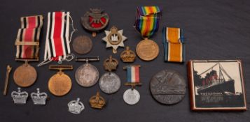 A WWI pair, together with a cased Lucitania Medal, and a group of cap badges etc,