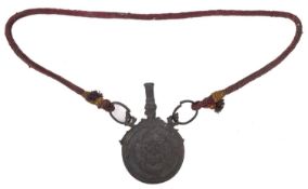 A 19th century Indo-Persian circular copper powder flask,