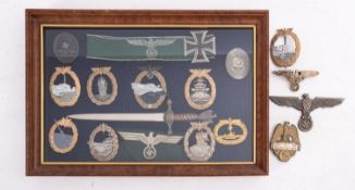 A framed display of reproduction German military badges,