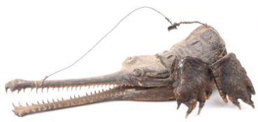 A late 19th/early 20th century taxidermy study of a Gharail crocodile head and feet, unsigned,
