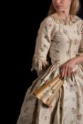 A late 18th century silk and floral embroidered open dress, square collar with entwined lace trim,