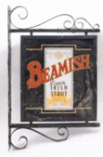 A 'Beamish Genuine Irish Stout' double sided exterior pub sign, mounted on a wrought iron bracket,