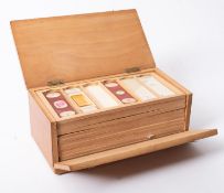 A late 19th early 20th century microscope slide box containing twelve trays,
