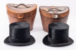 Two black felt top hats in leather cases, makers Scott& Co and Woodrow, both 54cm in size..