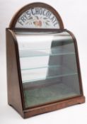 A late 19th century Fry's Chocolate bow fronted advertising case with arched panel glass shelves