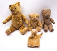 A mid 20th century blonde plush teddy bear, with plastic eyes, black stitched nose and mouth,