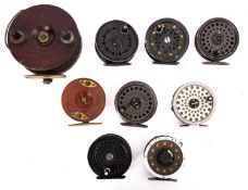 Two mahogany and brass fishing reels, together with a group of various other reels.