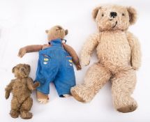 An early 20th century blonde plush Teddy bear, with glass eyes,