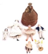 A bisque pincushion doll with four porcelain and bisque dolls house dolls,