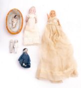 A German dolls house doll in a porcelain basket,