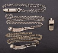 A BR(M) whistle, one other and two bosun's whistles.