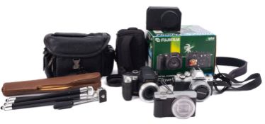 A Panasonic Lumix digital camera, together with two Fiji digital cameras and a Polaroid camera.