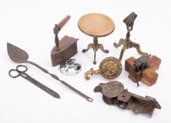A collection of various antique metalware, including a lock, servants' call bell, flat iron,