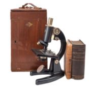 A Prior black lacquered microscope in a case, together with Cooke,