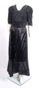 A late 19th early 20th century black silk and lace embroidered sleeveless bodice,