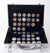 A case containing crown size and replica coins.