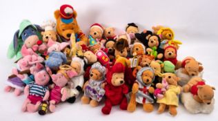 A collection of Disney 'Winnie The Pooh' soft toy figures in various costumes.