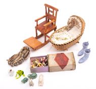 A doll's house cradle with linen and lace interior, approximate 11cm long,