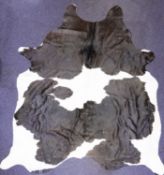 A large black and white Cow hide.