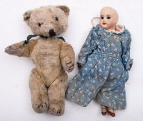 An SFBJ bisque head doll, with wooden body and limbs, in cotton dress and painted shoes,