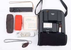 A Minox TLX subminiature camera with flash unit and a box of bulbs,