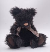 A black plush jointed Charlie Bears 'Eddie' CB614872, with bell neck bow and card tags,