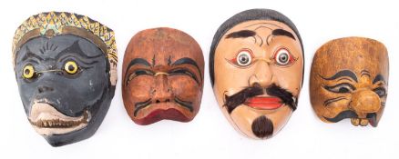 A group of four various Javanese wooden painted masks,