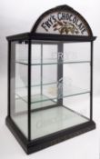 A Fry's Choice Chocolate flat fronted counter top display cabinet with milk glass half moon shape