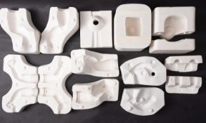 A collection of various plaster doll moulds