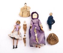 A small 19th century Grodnertal painted wooden doll with painted black hair peg jointed limbs,