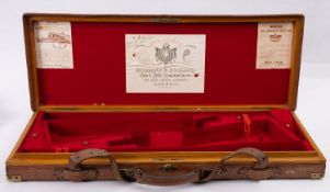 A Holland & Holland oak and leather bound double gun case, the exterior with brass mounted corners,