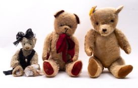 A mid 20th century blonde plush teddy bear, with plastic eyes,