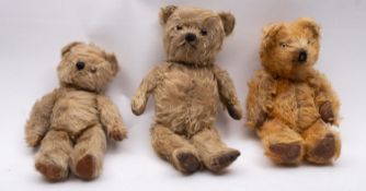 Three mid 20th century blonde plush teddy bears, with glass eyes, black stitched noses and mouths,
