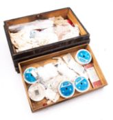 A collection of miscellaneous lace trim and edging in an associated wooden trunk,