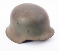 A German WWII M1944 steel helmet, the exterior with remains of insignia,
