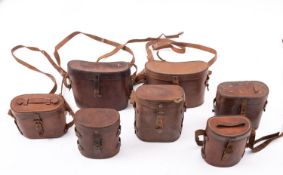 Seven various early 20th century brown leather binocular cases