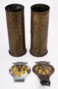 Two WWII trench art shell cases together with two later AA badges.