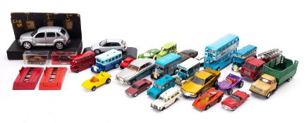 Dinky, Matchbox and others. An unboxed group of various cars, buses and commercial vehicles.