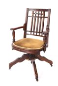 A Victorian oak revolving desk elbow cha