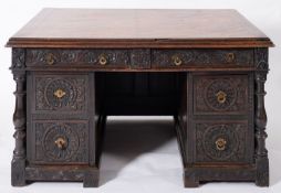 A Victorian carved oak pedestal desk, la