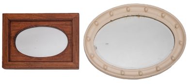 A repousse copper framed oval wall mirro