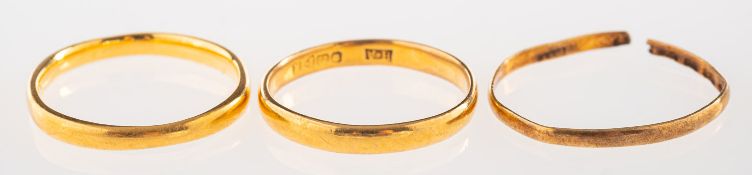 A group of three 22ct gold wedding bands, all UK hallmark, total gross weight 4.6grams, (3).