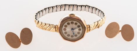 A pair of cufflinks and a vintage wristwatch,