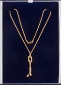A 9ct yellow gold lariat necklace, a snake chain with an open knot and suspending tassels & beads,