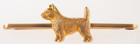 An antique dog bar brooch, depicting a terrier, marked 9ct, makers mark J,G &S, length approx. 5.