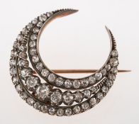 A Victorian diamond crescent brooch, claw and grain set with three rows of old-cut diamonds,